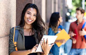 Female Student leaning on wall