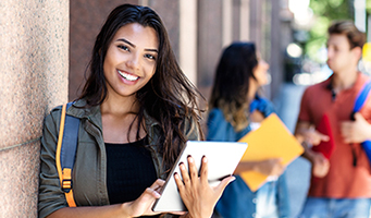 Female Student leaning on wall
