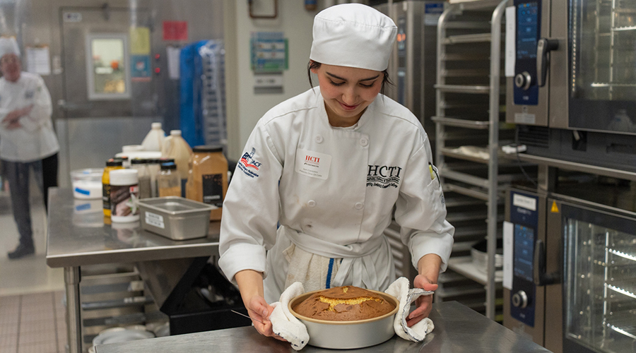 Girl chef working on cake