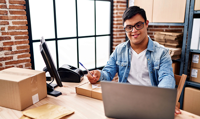 Male behind laptop